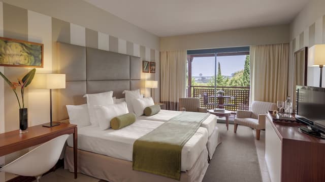 A twin room with a terrace at El Rompido Precise Golf Resort